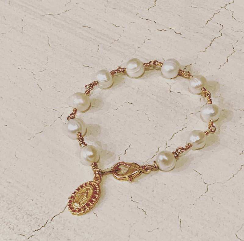 Children's pearl bracelet w/ religious medallion